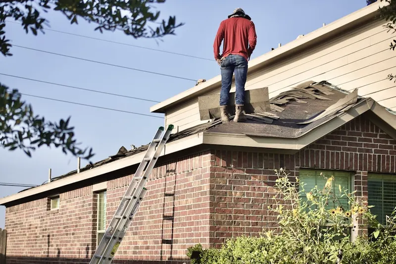 Professional roofer working on a residential roof in College View